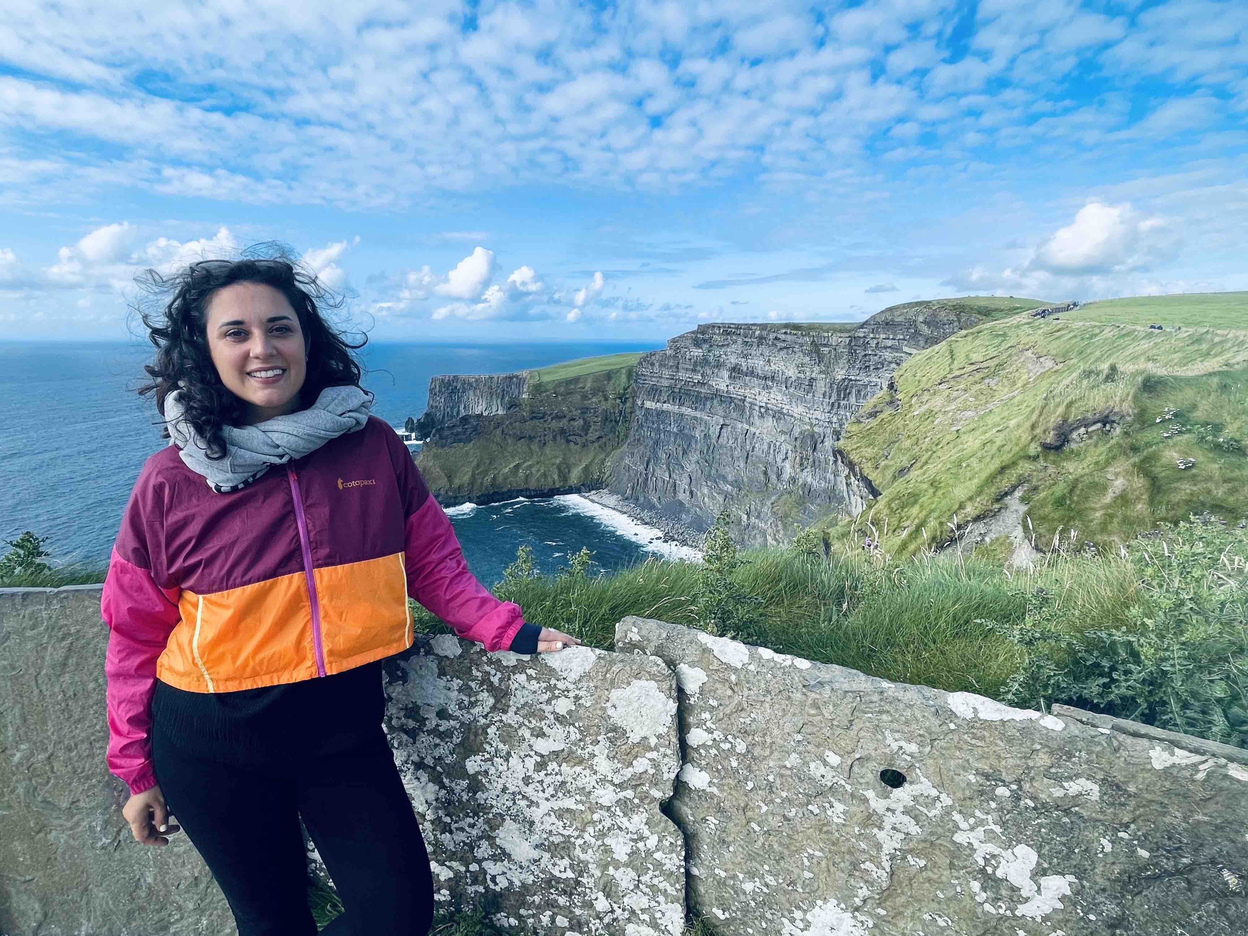 Francesca posing with the Cliffs of Moher, Ireland in the background